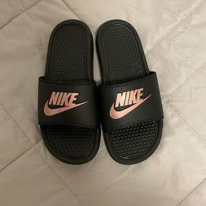 Black and rose gold Nike slides